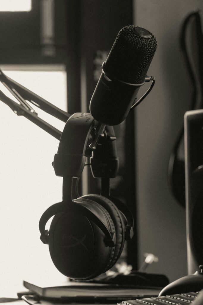 Headphones hanging from a podcast microphone